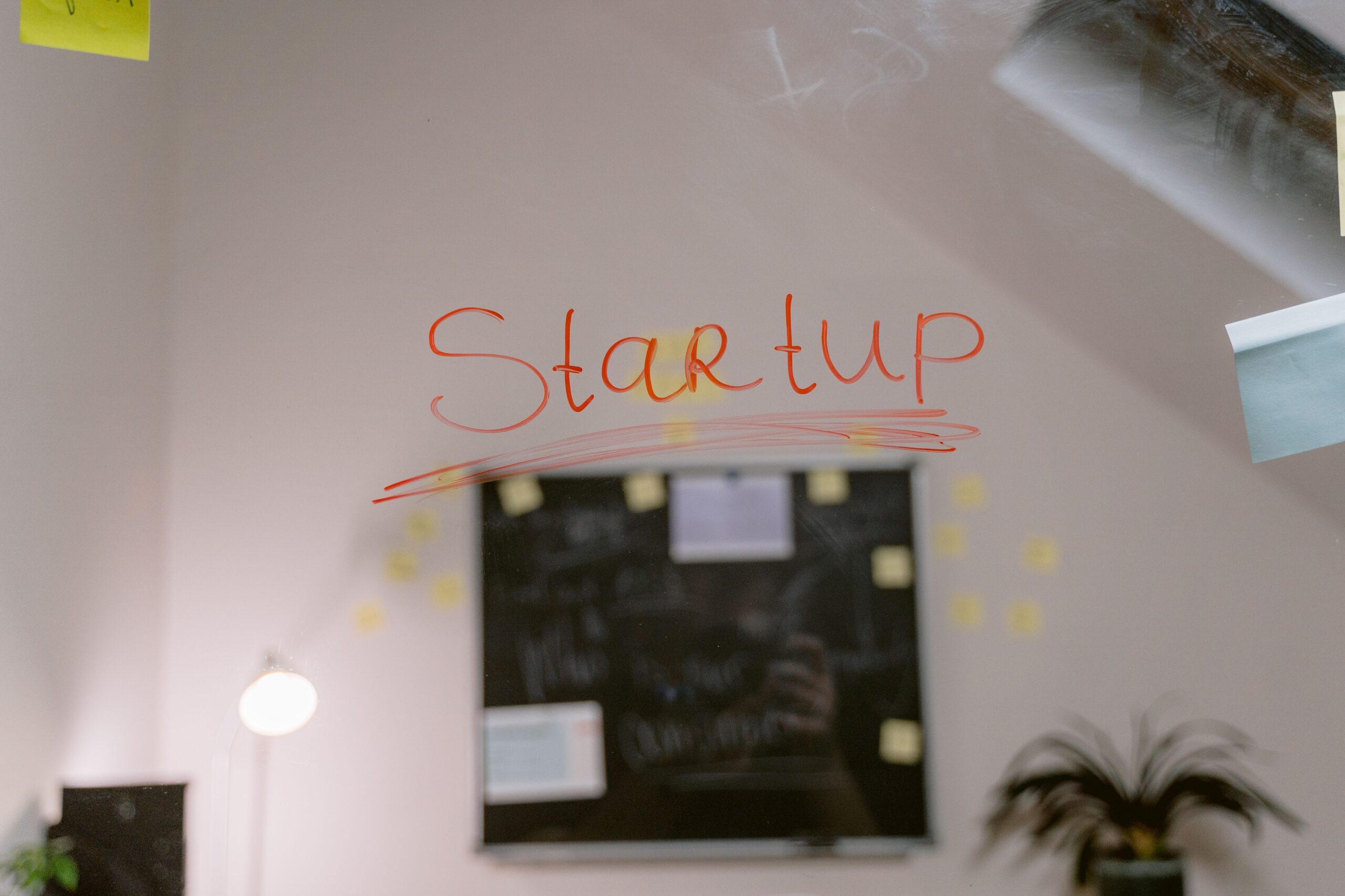 pexels photo 6914070 6914070 Close-up of 'Startup' written on a glass panel in an office setting.